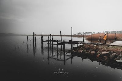 Pier on lake against clear sky