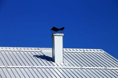 Low angle view of building against clear blue sky