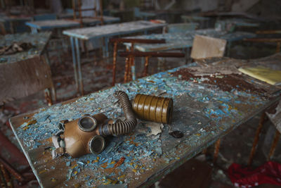 High angle view of gas mask on rusty table