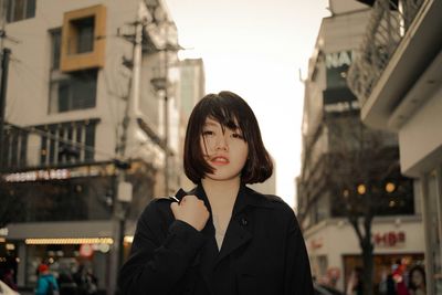 Portrait of woman standing in street