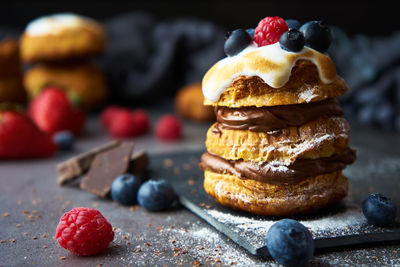 Sweet puff pastry with chocolate filling and accompanied by blueberries and raspberries