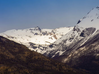 Scenic view of snowcapped mountains against clear sky