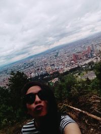 Portrait of man in city against sky