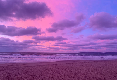 Scenic view of beach against sky during sunset