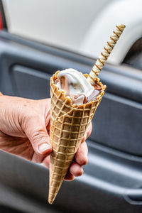 Close-up of hand holding ice cream cone