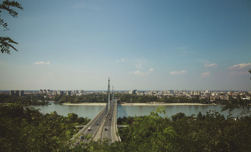 Bridge over river with city in background