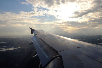 Cropped image of airplane flying over city
