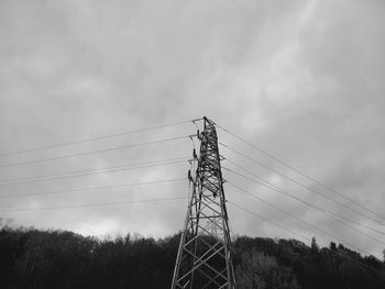 Low angle view of electricity pylon against sky
