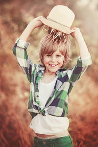 Portrait of smiling boy standing outdoors