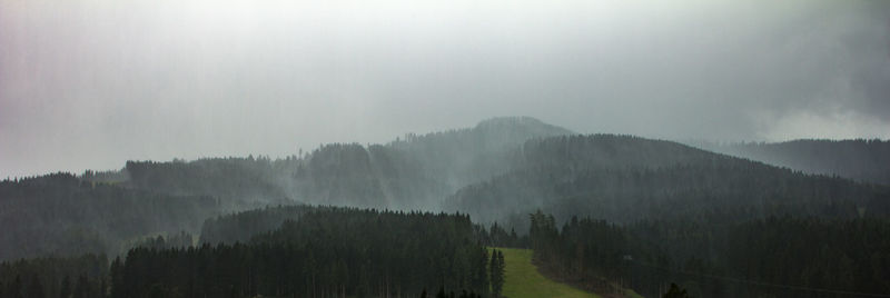 Panoramic shot of trees and mountains against sky