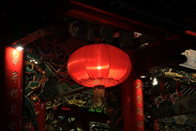 Low angle view of illuminated lanterns hanging in temple