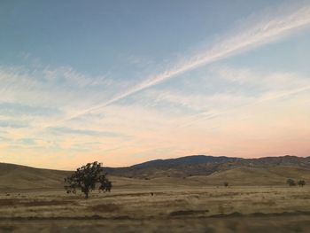 Scenic view of desert against sky during sunset