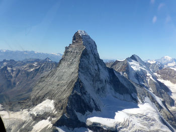 Scenic view of snowcapped mountains against clear sky
