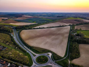 High angle view of agricultural field against sky during sunset