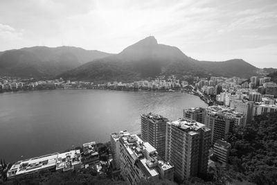 High angle view of city by sea against sky