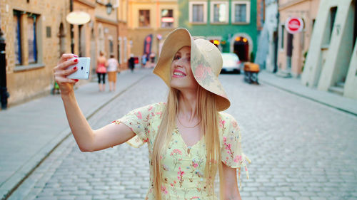 Rear view of woman standing in city