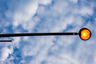 Low angle view of light bulb against sky