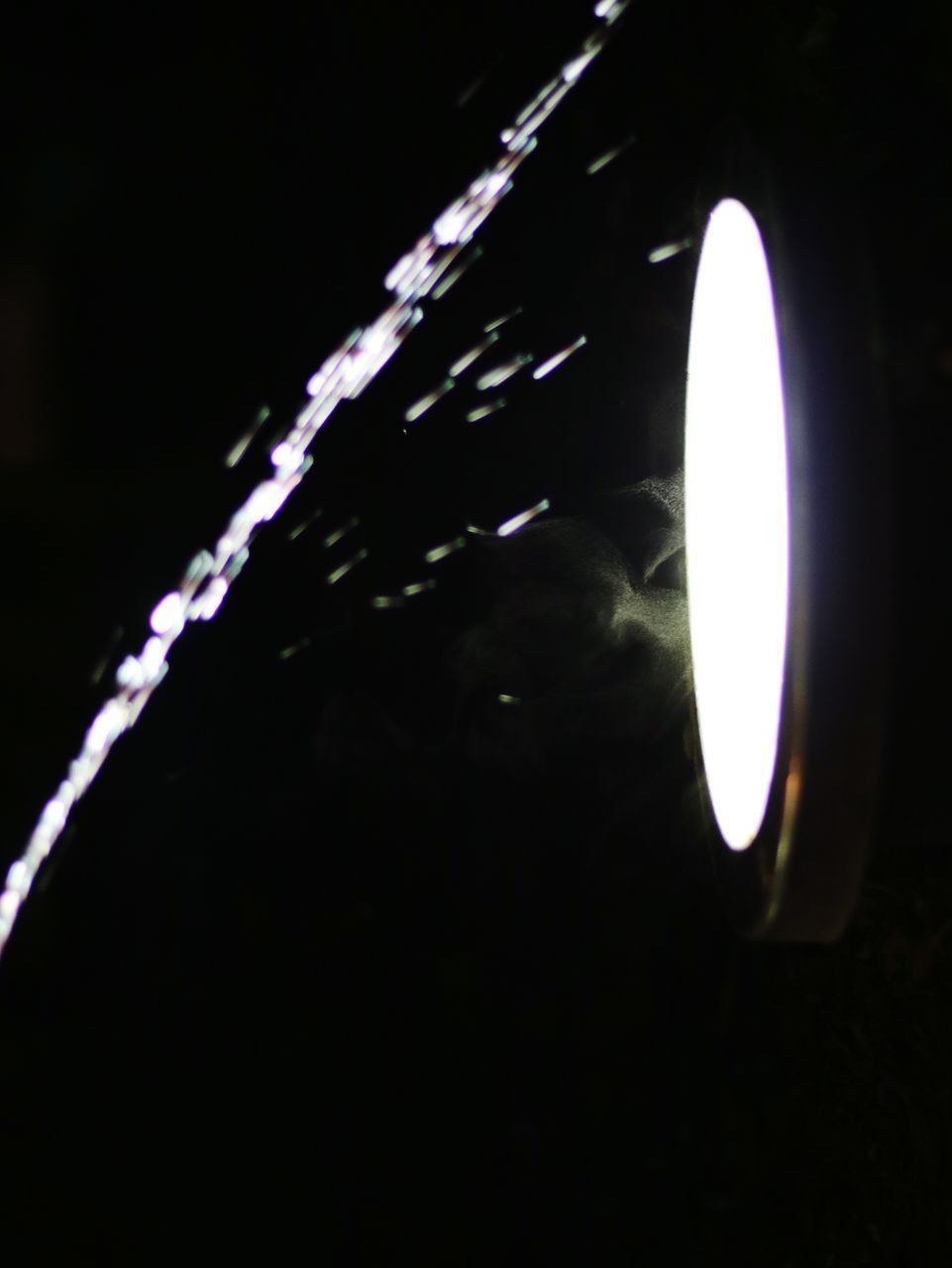 CLOSE-UP OF ILLUMINATED LAMP AGAINST DARK SKY