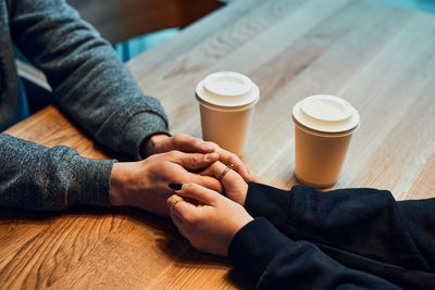 Loving couple holding hands sitting in cafe drinking coffee. loving people. valentines day 