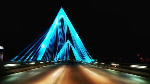 Light trails on suspension bridge at night