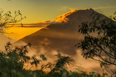 Low angle view of silhouette mountains against sky at sunset