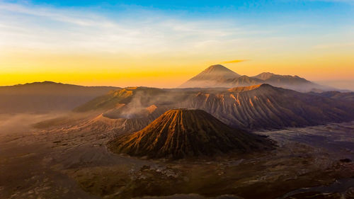 Panoramic view of volcanic landscape against sky during sunset
