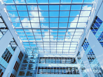 Low angle view of modern building against blue sky