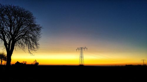 Silhouette trees against sky during sunset