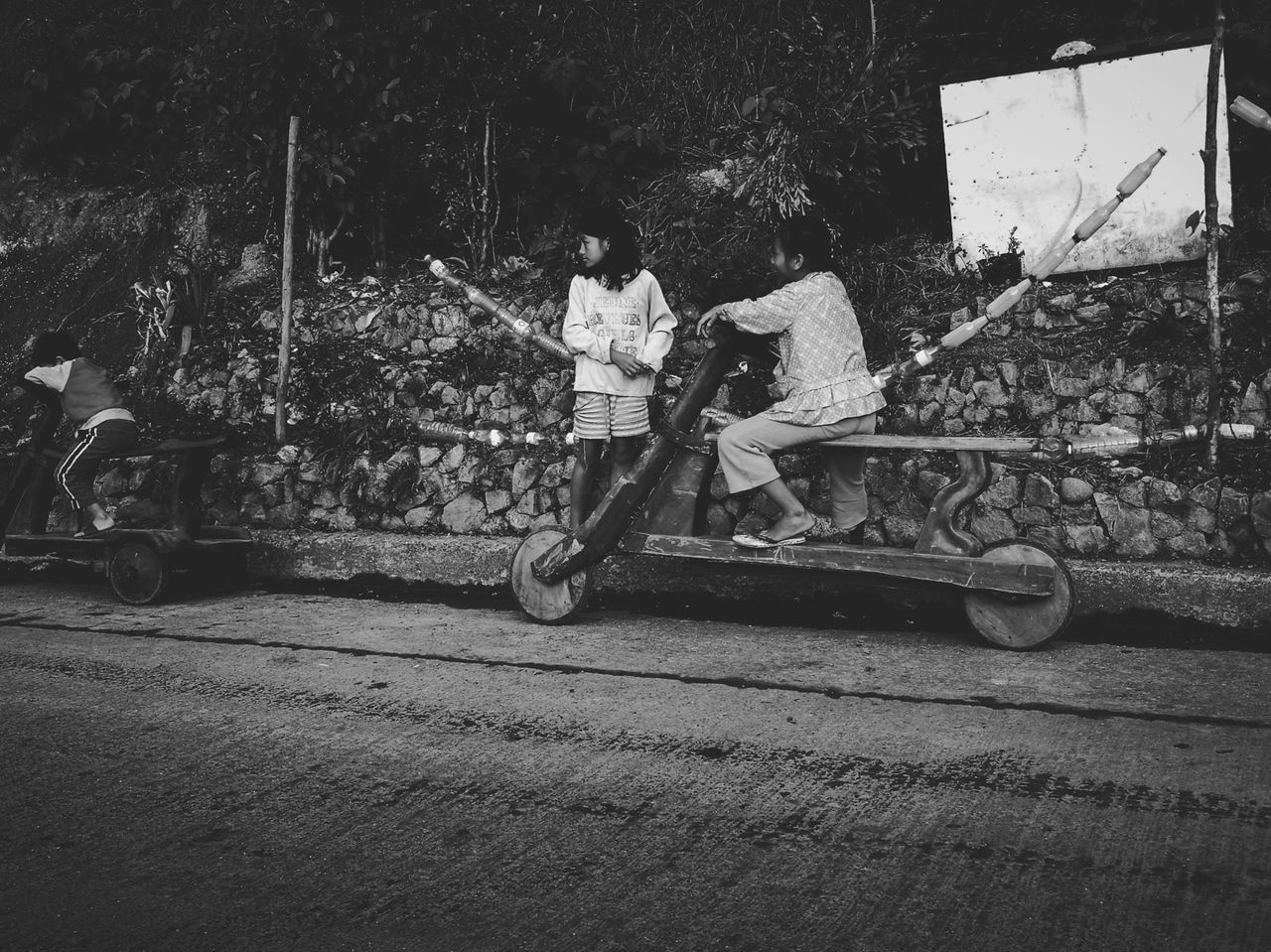 CHILDREN PLAYING WITH SKATEBOARD