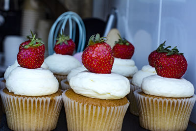 Close-up of strawberries on cupcakes 