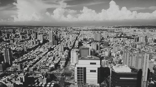 Buildings against cloudy sky