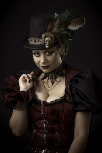 Woman in costume against black background