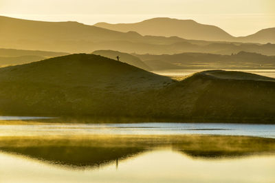 Scenic view of lake against sky during sunset