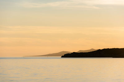 Scenic view of sea against sky at sunset