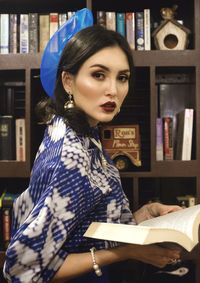 Portrait of young woman reading book