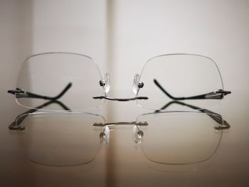 Close-up of eyeglasses on glass table