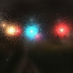 Raindrops on glass window at night