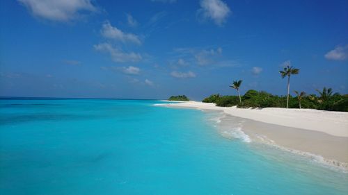 Scenic view of sea and sand beach against sky