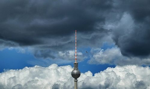 Low angle view of eiffel tower against cloudy sky