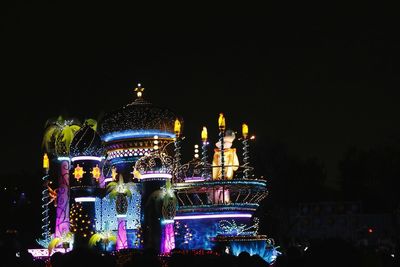 Illuminated temple against clear sky at night