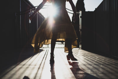 Low section of woman walking on staircase