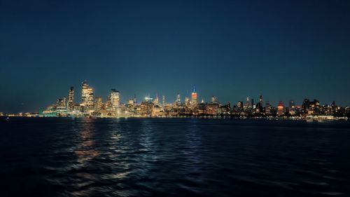 Illuminated city at waterfront