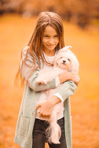 Portrait of woman holding dog