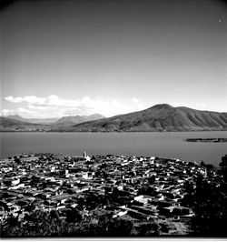 Scenic view of sea and mountains against clear sky