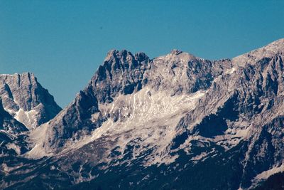 Scenic view of snowcapped mountains against clear sky