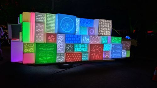 Close-up of illuminated lighting equipment against black background