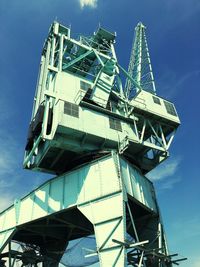 Low angle view of crane against sky