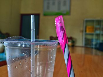 A pen leaning against a plastic cup