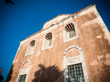 Low angle view of building against blue sky