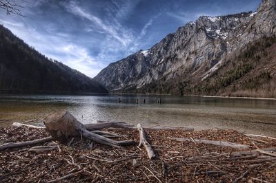 Scenic view of lake by mountains against sky